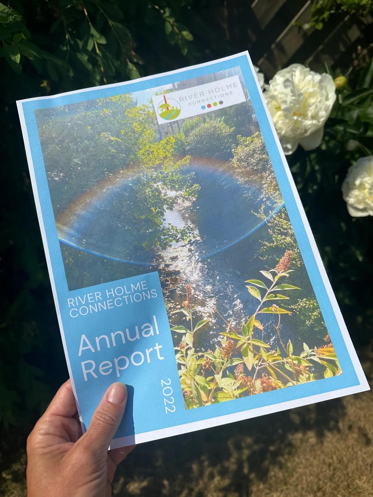 Sophie of Sophie Seddon PR holding a copy of the River Holme Connections Annual Report 2023.