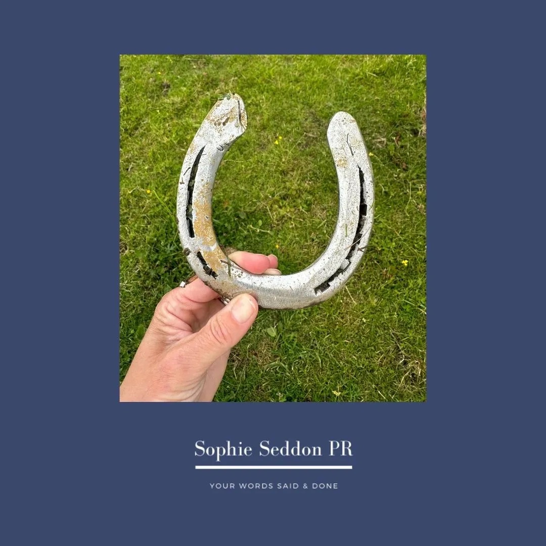Sophie, of Sophie Seddon PR, holding up the horseshoe her daughter's pony had lost in a field and of which they found.