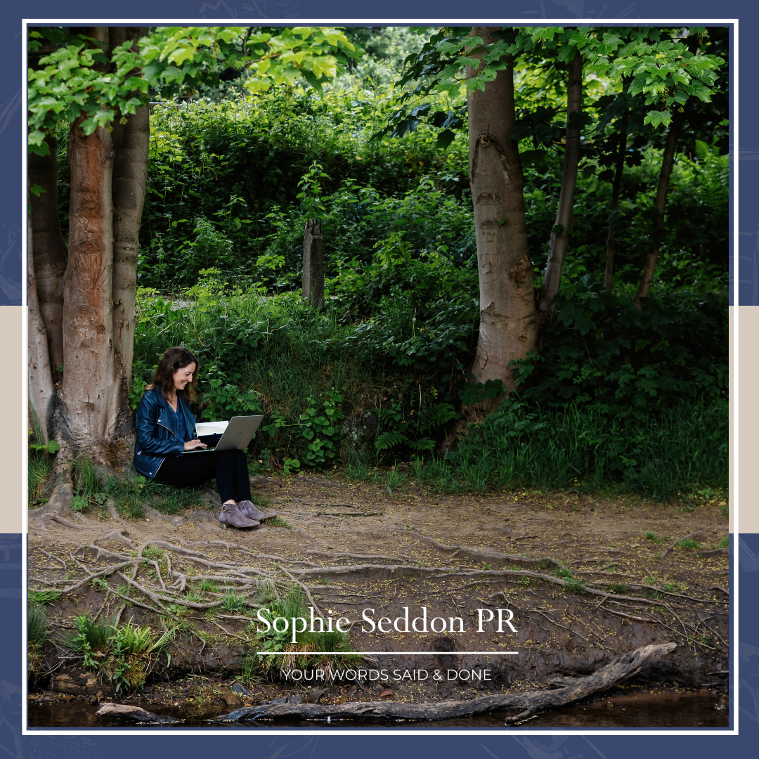 Sophie Seddon of Sophie Seddon PR sat outside, beneath of tree writing in her notebook about values led business decisions.