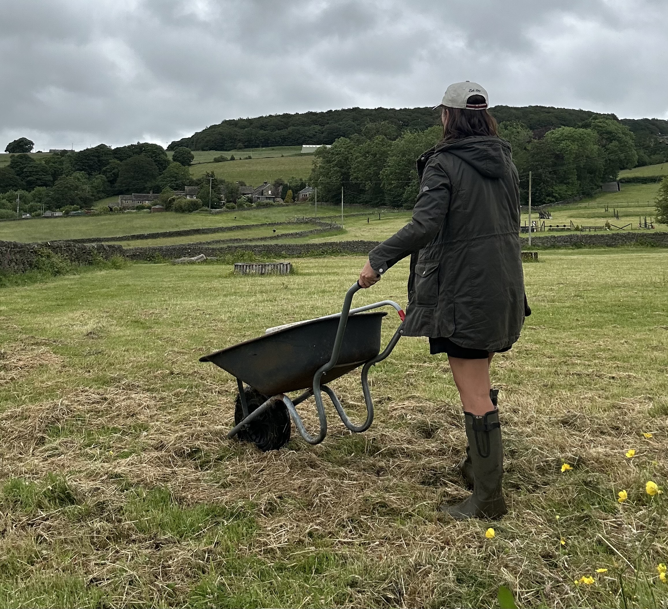 PR consultant in a muddy field with a wheelbarrow on a wet Wednesday afternoon.