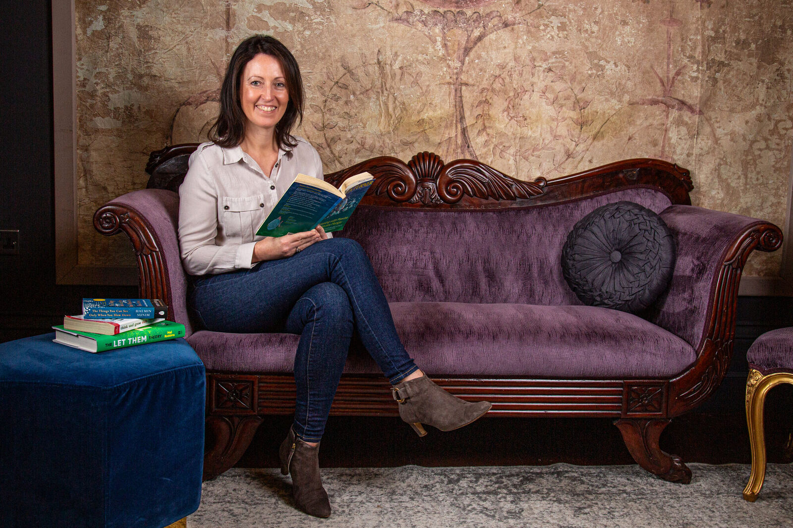 Sophie Seddon sitting on a sofa with an open notebook